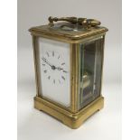 A brass cased carriage clock and key.