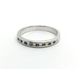 An 18carat gold ring. half hoop eternity ring set