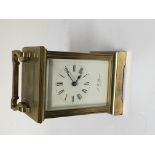 A brass cased carriage clock maker JW Benson London with key and seen working.