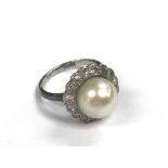 A pearl and diamond ring
