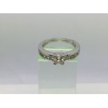 An 18ct white gold diamond ring set with a central