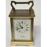A brass cased carriage clock JW Benson London seen
