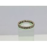 A gold full eternity ring set with CZ stones, appr