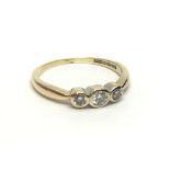 An 18ct gold three stone diamond ring, approx.20ct