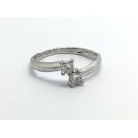 An 18carat white gold ring set with two diamonds a
