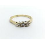 An 18ct gold three stone diamond ring, approx .20c