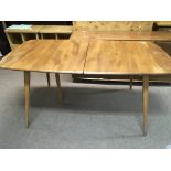 An Ercol dining table with extra leaf and ten chai