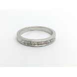 An 18ct white gold half eternity diamond ring set