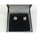 A boxed pair of 18ct white gold diamond solitaire