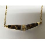 A 14carat gold necklace with tigers eye and diamond set pendent
