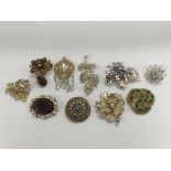 A collection of mid 20th Century gem set brooches.