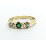 An 18ct gold emerald and diamond ring, approx .30c