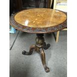 An inlaid and carved walnut occasional table with