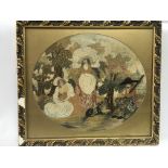 An antique framed tapestry picture of figures in a