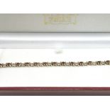 A 9ct gold bracelet set with rubies and diamonds,