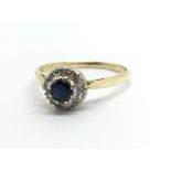 An 18ct gold sapphire and diamond cluster ring, ap