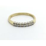 An 18ct gold seven stone diamond ring, approx .15c