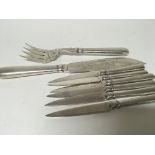 A set of Chinese white metal cutlery six knifes an