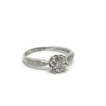 A 9ct white gold solitaire diamond ring with furth