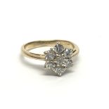 An 18ct gold seven stone diamond ring in a flowerh