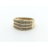 An 18carat gold ring set with three rows of brilli