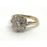 An 18ct gold nine stone diamond cluster ring, appr