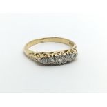 An 18carat gold ring set with a row of five diamon
