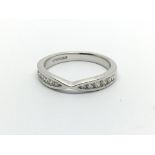 An 18carat white gold ring.a half hoop eternity ri