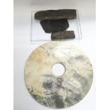 Three neolithic carved stones plus a marble disc (