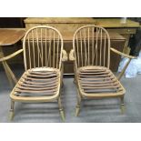 A pair of Ercol open armchair.