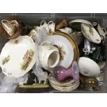A box containing decorative ceramics and other odd
