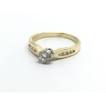 An 18ct gold solitaire diamond ring with further d