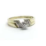 A 9ct gold solitaire diamond ring with further dia
