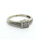 An 18ct white gold cluster ring set with princess