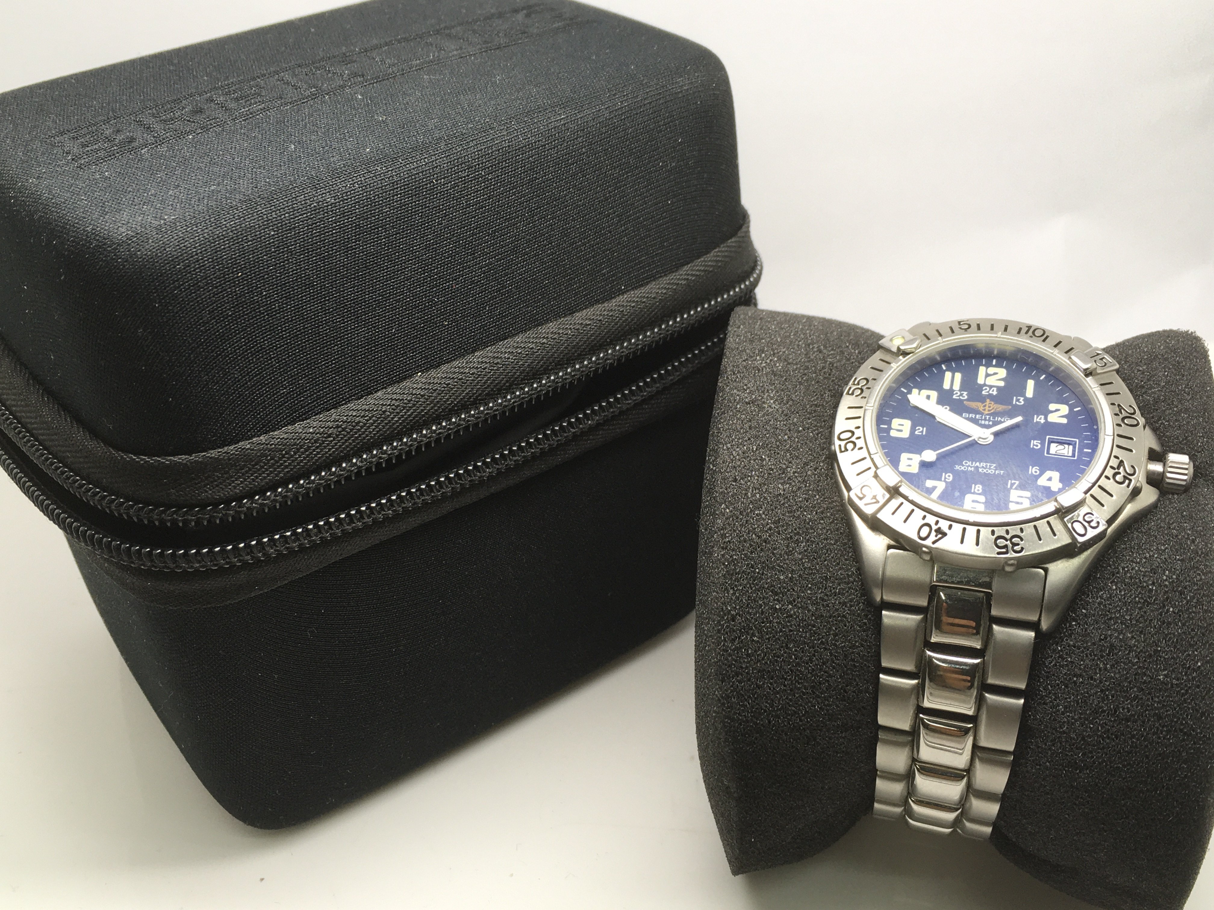 A gents Brietling Colt watch with Breitling travel