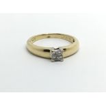 An 18carat gold ring set with a square of Princess