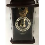 A Morden Skelton wall clock striking on a bell .