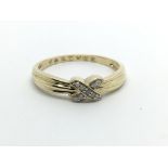 A 14carat gold ring set with a cross pattern of di