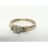 A 9ct gold solitaire diamond ring with further dia