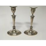 A pair of George III style silver candle sticks of