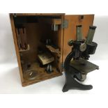 A Carl Zeiss Jena microscope in a wooden case toge