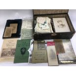 A box of mixed postcards and ephemera.