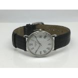 A gents Tissot watch with white face and date aper