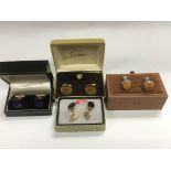 Four boxed pairs of cufflinks.