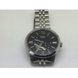 A gents Fossil automatic watch with black face and