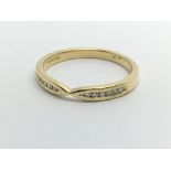 An 18carat gold ring set with a row of diamonds ri