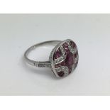 A Victorian style platinum panel ring set with a c