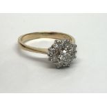 An 18ct gold nine stone diamond cluster ring in th