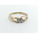 A vintage 18ct gold two stone diamond ring, approx