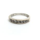 An 18ct white gold seven stone half eternity ring,